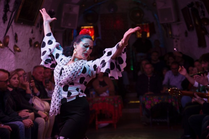 a group of people performing on stage in front of a crowd