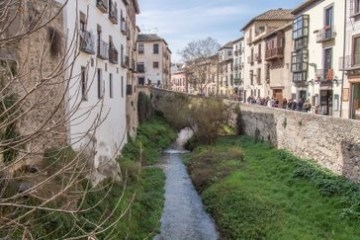 a narrow city street with old buildings in the background
