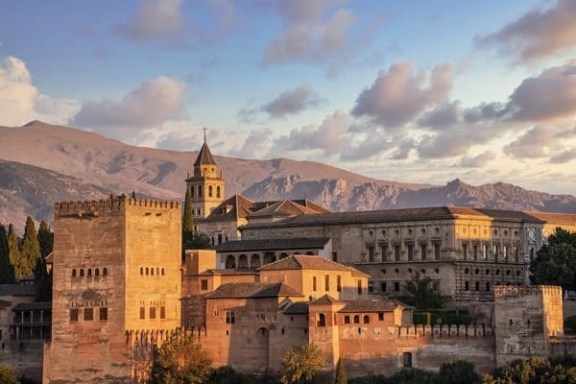 a castle like building with a mountain in the background